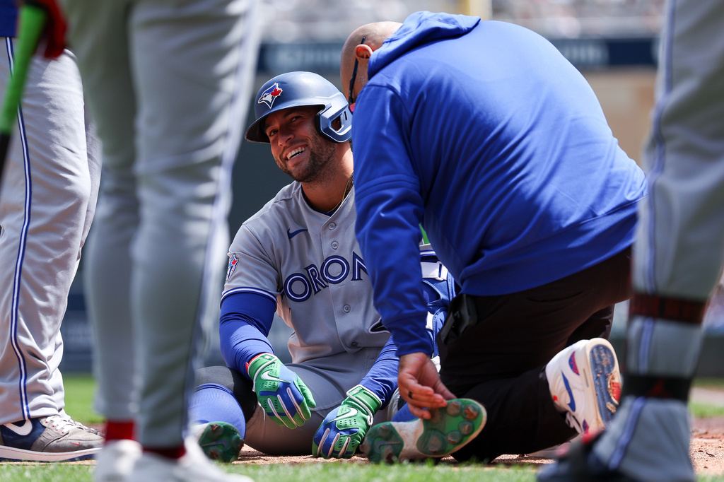 Toronto Blue Jays designated hitter George Springer is tended to after getting hit by a pitch during the third inning of a baseball game against the Minnesota Twins, Saturday, May 2, 2026, in Minneapolis. (AP Photo/Matt Krohn)