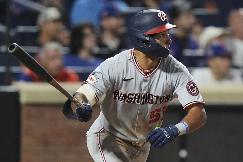 Washington Nationals' Daylen Lile (51) watches a ball he hit for a two-run inside-the-park home run during the 11th inning of a baseball game against the New York Mets Saturday, Sept. 20, 2025, in New York. (AP Photo/Frank Franklin II)
