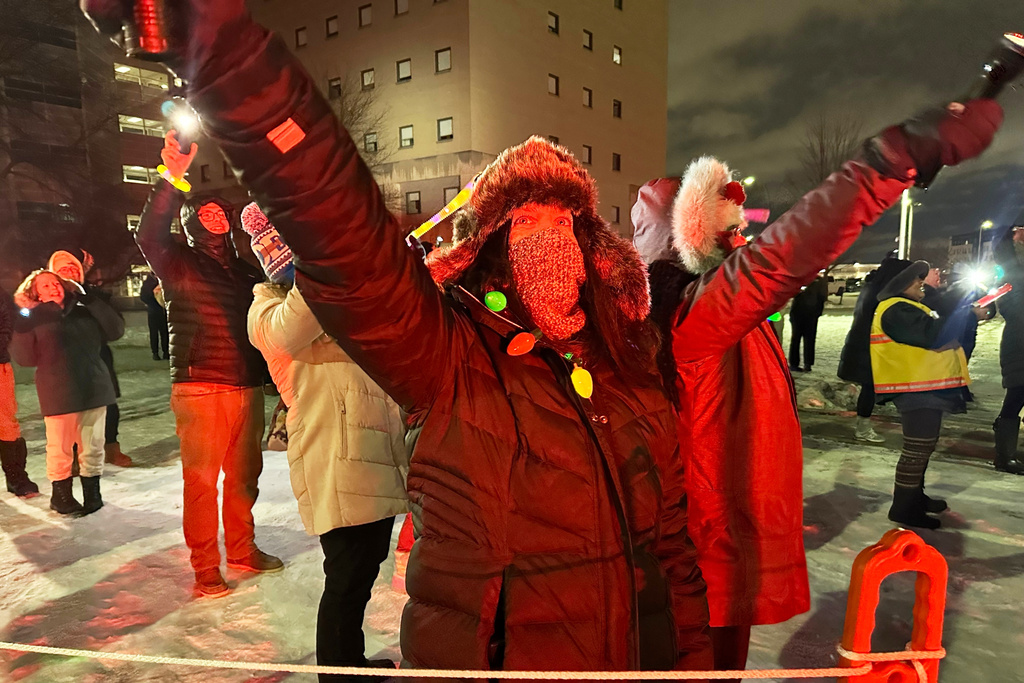 Volunteers shine lights up into the pediatric wing of Corewell Health Children's during a Moonbeams for Sweet Dreams event Saturday, Dec. 13, 2025, in Royal Oak, Mich. (AP Photo/Mike Householder)