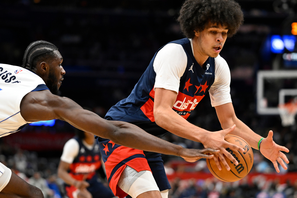 Dallas Mavericks Moussa Cisse, left, knocks the ball loose from the hands of Washington Wizards forward Kyshawn George during the first half of an NBA basketball game Saturday, Nov. 8, 2025, in Washington. (AP Photo/John McDonnell)
