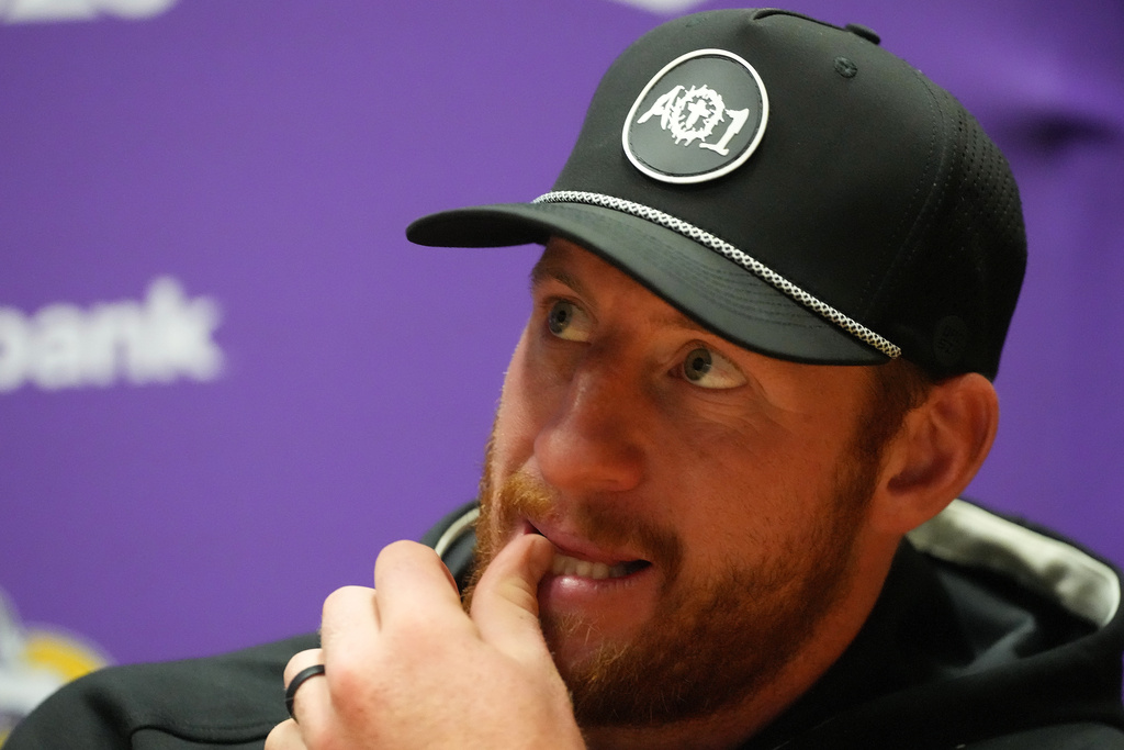 Minnesota Vikings quarterback Carson Wentz (11) reacts during a press conference ahead of their match against Pittsburgh Steelers in Dublin, Friday, Sept. 26, 2025.(AP Photo/Frank Augstein)