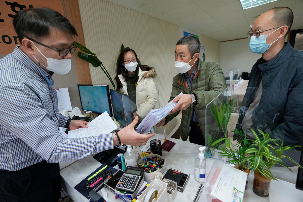 FILE - Peter Møller, second from right, attorney and co-founder of the Danish Korean Rights Group, submits the documents at the Truth and Reconciliation Commission in Seoul, South Korea, Nov. 15, 2022. (AP Photo/Ahn Young-joon, File)