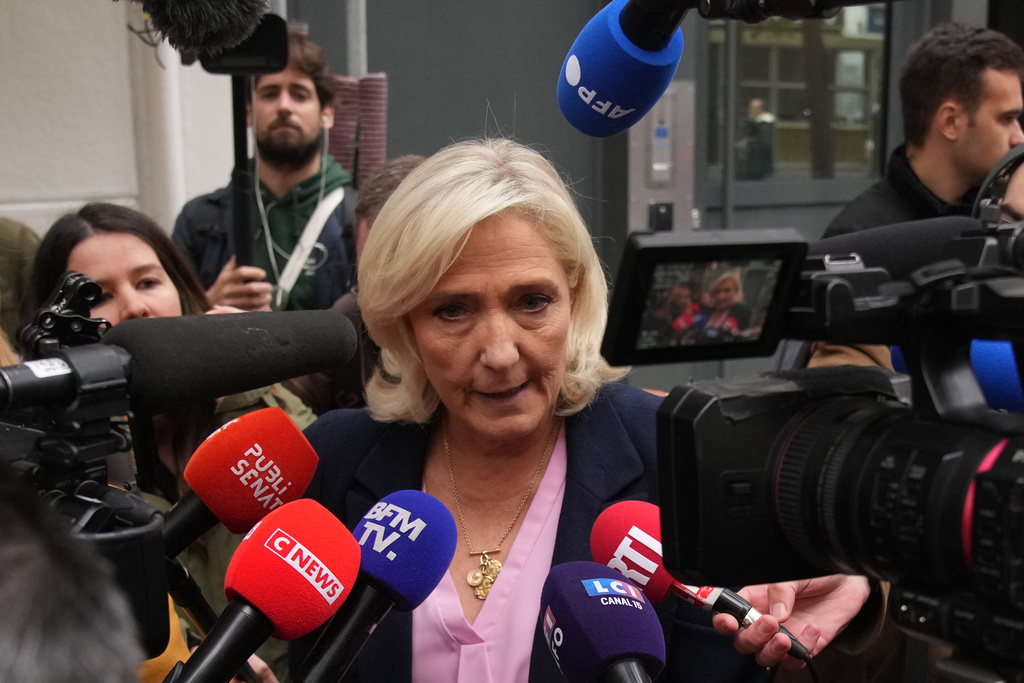French far right leader Marine Le Pen talks to the media following a meeting at the National Rally party headquarters, after France's prime minister Sebastien Lecornu resigned plunging the country into a deep political crisis. Monday, Oct. 6, 2025 in Paris. (AP Photo/Christophe Ena)