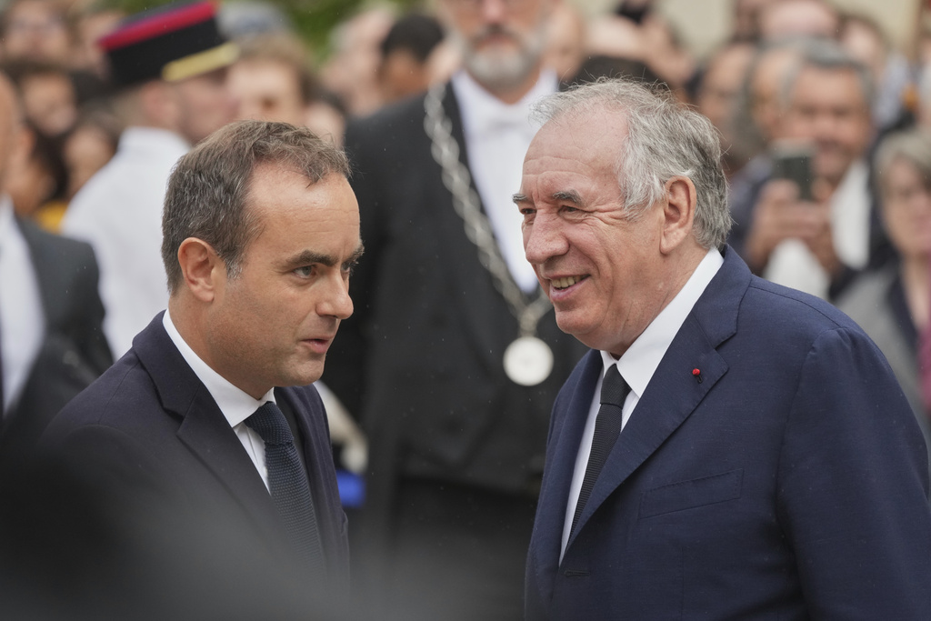 Newly named Prime Minister Sebastien Lecornu, left, is welcomed by outgoing French Prime Minister Francois Bayrou, right, for a handover ceremony at the Prime Minister residence, in Paris, France, Wednesday, Sept. 10, 2025. (AP Photo/Christophe Ena)