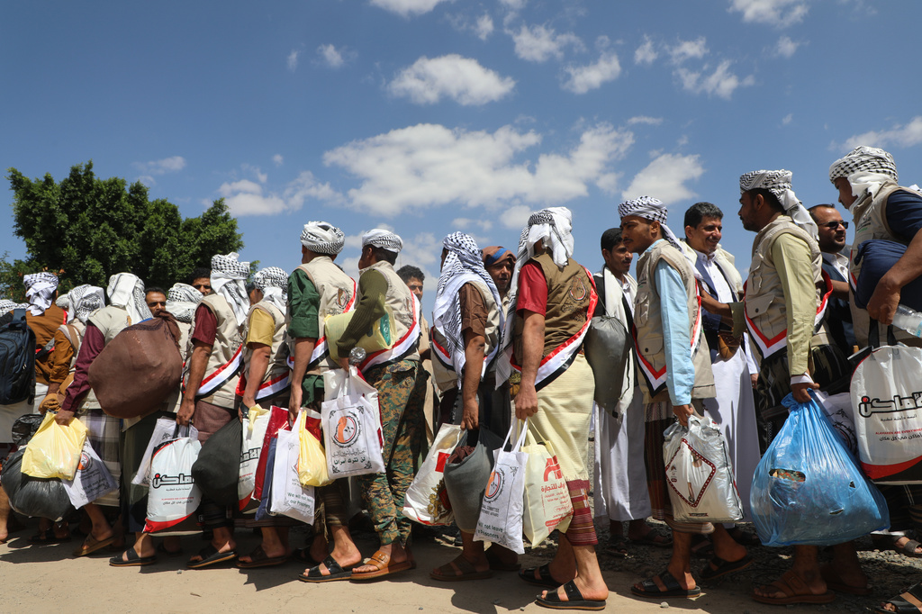 Houthi prisoners freed in Mokha carry their belongings as they arrive in Sanaa, Yemen, Saturday, Sept. 12, 2026, following the Houthi takeover of the southern Red Sea port city. (AP Photo)
