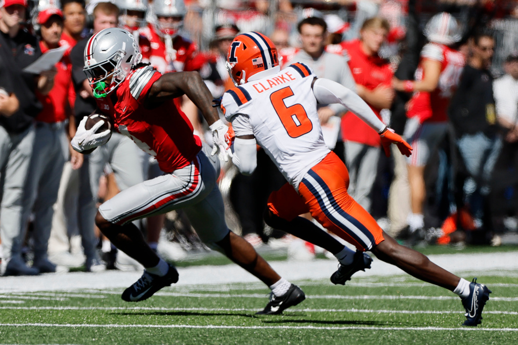 Ohio State wide receiver Jeremiah Smith, left, is forced out of bounds by Illinois defensive back Juice Clarke during the first half of an NCAA college football game, Saturday, Sept. 26, 2026, in Columbus, Ohio. (AP Photo/Jay LaPrete)