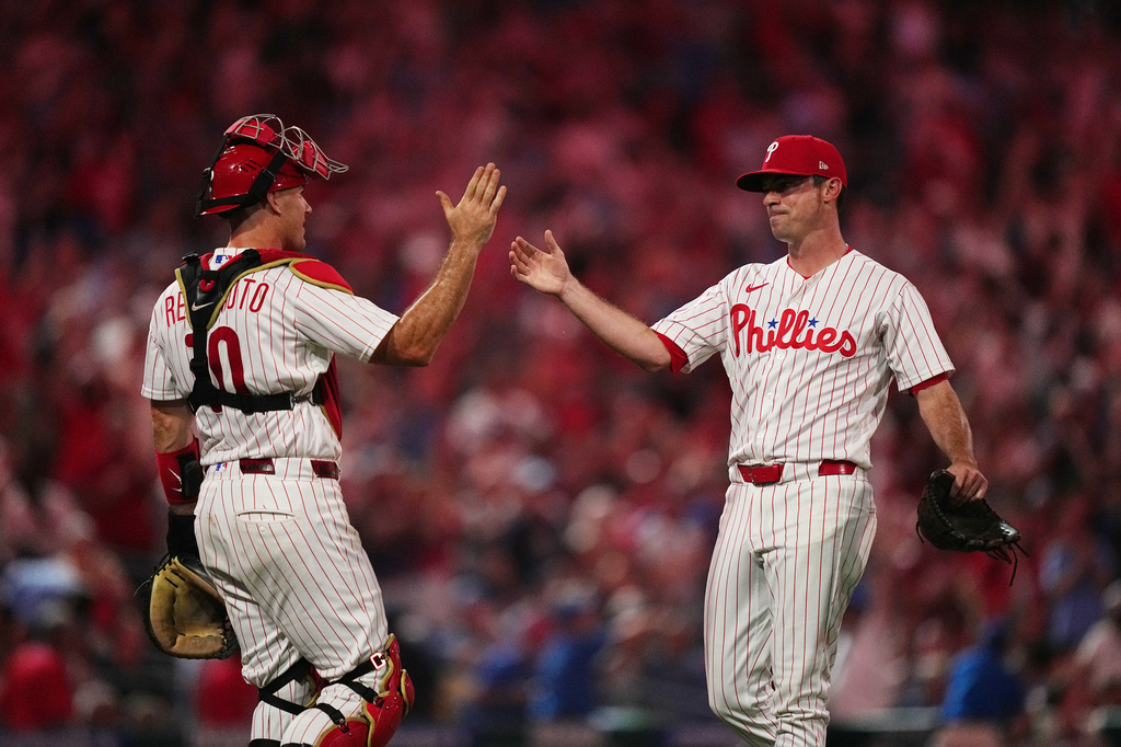 Philadelphia Phillies pitcher Brooks Raley, right, and catcher J.T. Realmuto celebrate after the Phillies won a baseball game against the Miami Marlins, Tuesday, Aug. 18, 2026, in Philadelphia. (AP Photo/Matt Rourke)