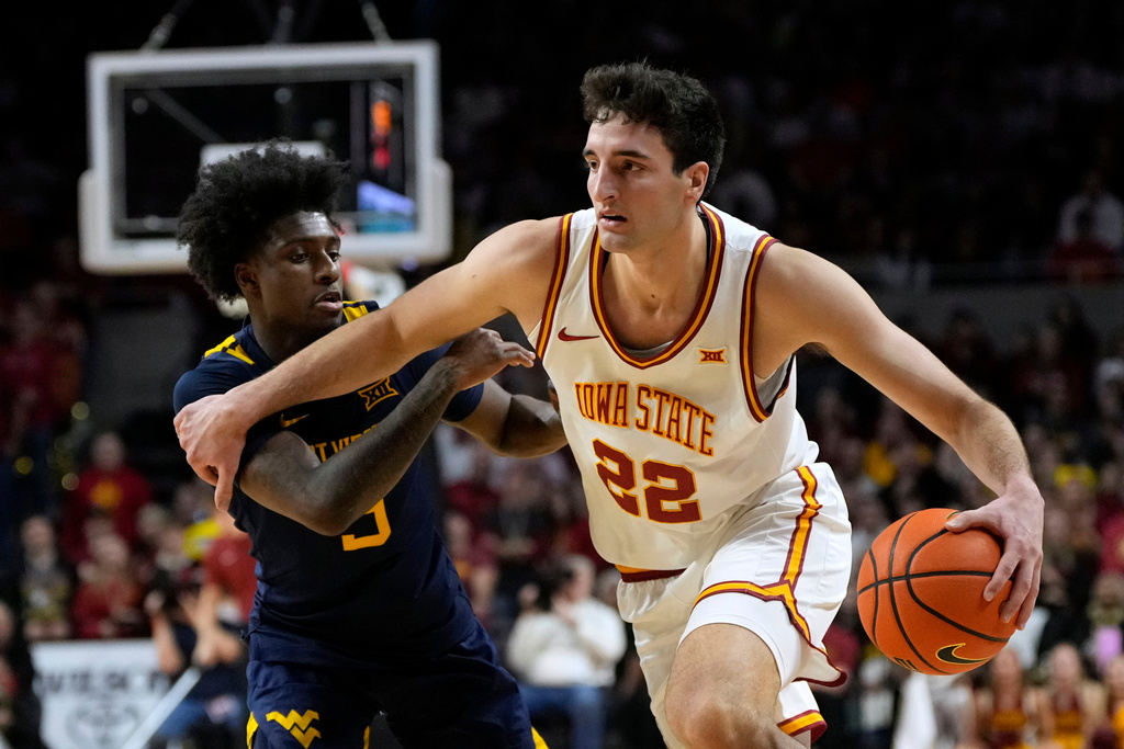 Iowa State forward Milan Momcilovic (22) drives past West Virginia guard Honor Huff during the second half of an NCAA college basketball game, Friday, Jan. 2, 2026, in Ames, Iowa. (AP Photo/Charlie Neibergall)