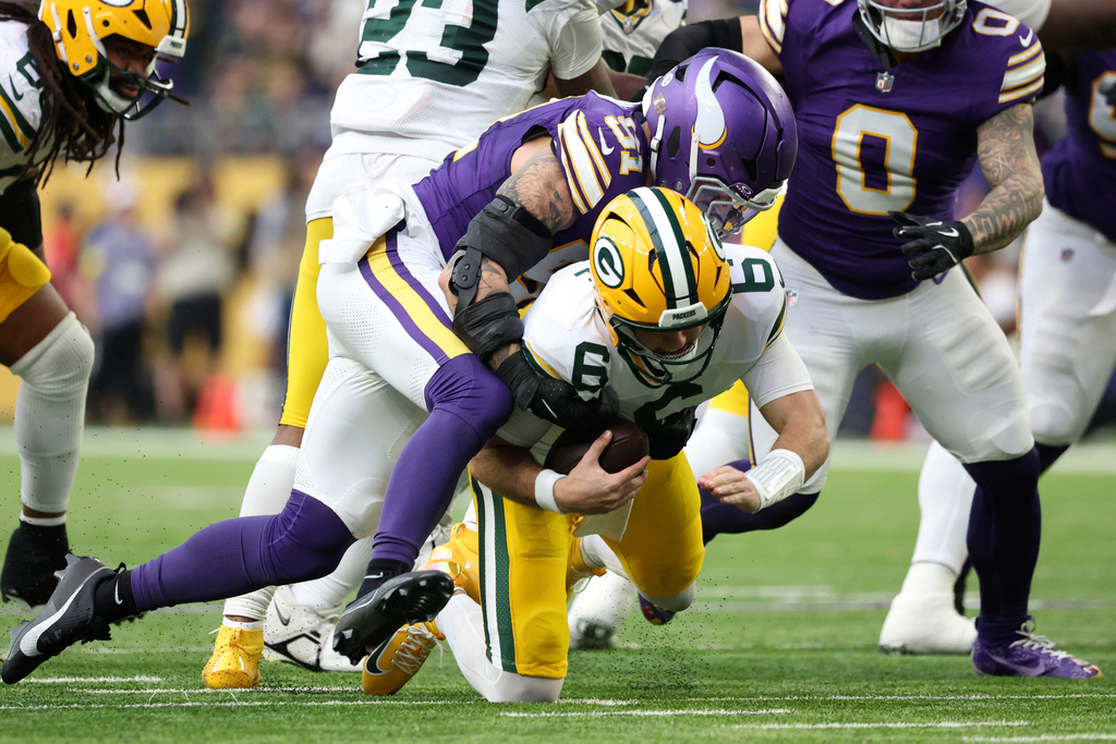 Minnesota Vikings linebacker Blake Cashman (51) sacks Green Bay Packers quarterback Clayton Tune (6) during the second half of an NFL football game, Sunday, Jan. 4, 2026, in Minneapolis. (AP Photo/Ellen Schmidt)