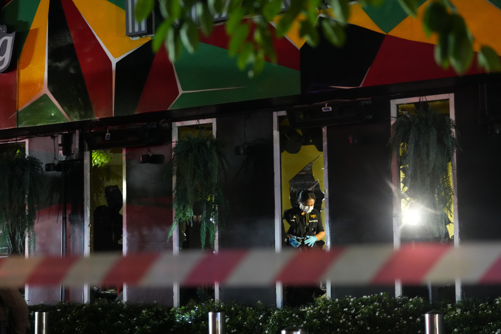Forensic police officers inspect the site of a fire in Bangkok, Thailand, Monday, July 13, 2026. (AP Photo/Sakchai Lalit)
