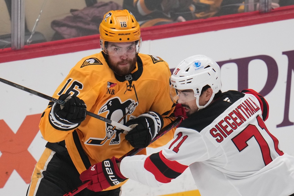 New Jersey Devils' Jonas Siegenthaler (71) defends against Pittsburgh Penguins' Justin Brazeau (16) during the first period of an NHL hockey game in Pittsburgh, Thursday, Feb. 26, 2026. (AP Photo/Gene J. Puskar)