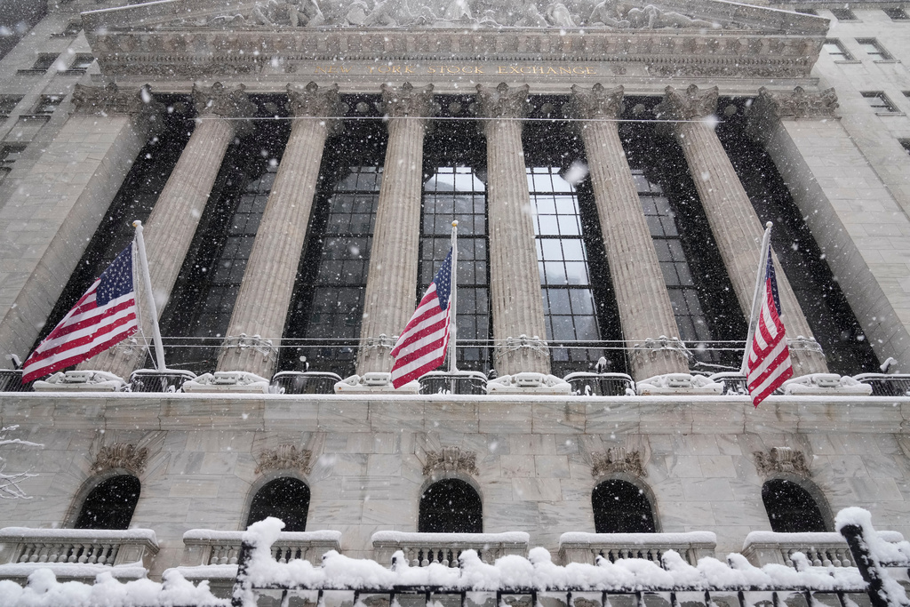 Snow falls outside the New York Stock Exchange, Monday, Feb. 23, 2026, in New York. (AP Photo/Seth Wenig)