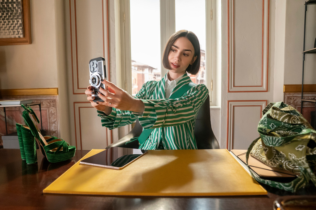 This image released by Netflix shows Lile Collins in a scene from "Emily In Paris." (Caroline Dubois/Netflix via AP)