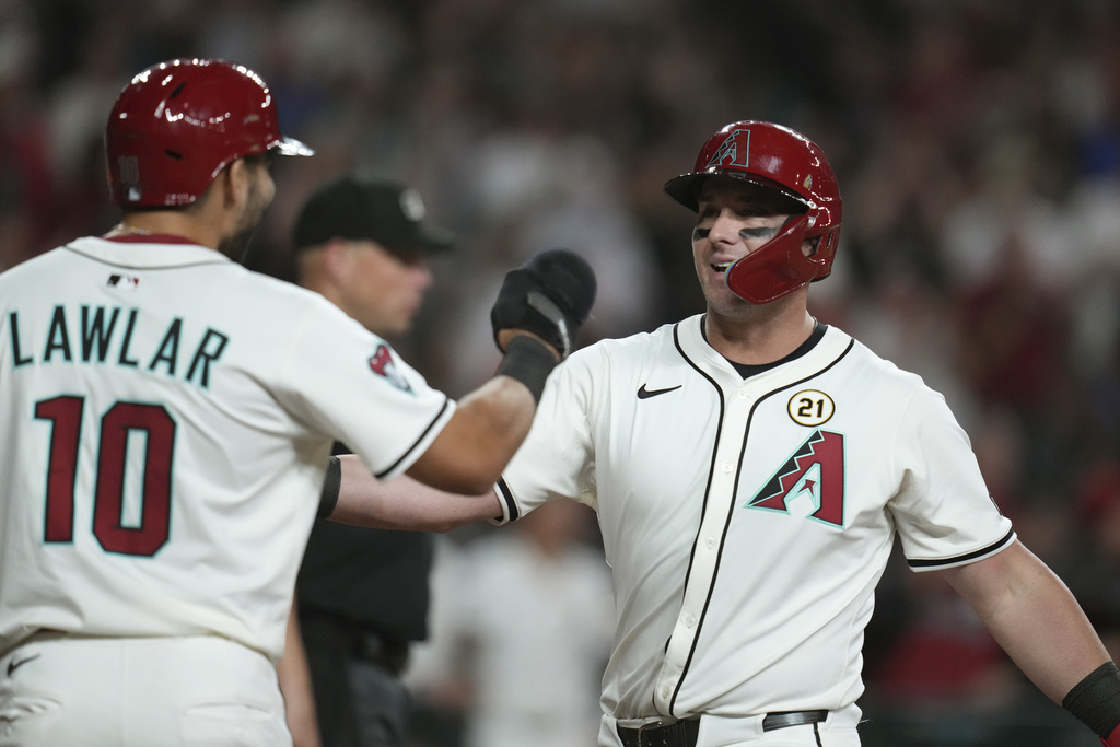 Arizona Diamondbacks' James McCann, right, celebrates his two-run home run against the San Francisco Giants with Diamondbacks shortstop Jordan Lawlar (10) during the sixth inning of a baseball game Monday, Sept. 15, 2025, in Phoenix. (AP Photo/Ross D. Franklin)