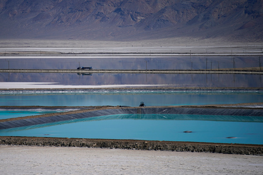 FILE - A truck drives between brine evaporation ponds at Albemarle Corp.'s Silver Peak lithium facility Oct. 6, 2022, in Silver Peak, Nev. (AP Photo/John Locher, File) FILE - A truck drives between brine evaporation ponds at Albemarle Corp.'s Silver Peak lithium facility Oct. 6, 2022, in Silver Peak, Nev. (AP Photo/John Locher, File)