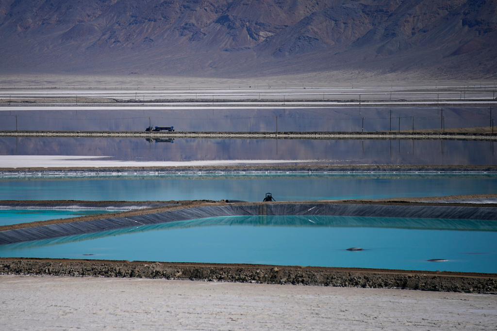 FILE - A truck drives between brine evaporation ponds at Albemarle Corp.'s Silver Peak lithium facility Oct. 6, 2022, in Silver Peak, Nev. (AP Photo/John Locher, File)
