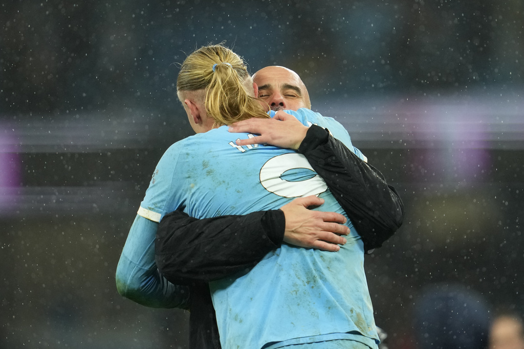 Manchester City's head coach Pep Guardiola hugs Erling Haaland after the English Premier League soccer match between Manchetser City nad Newcastle in Manchester, England, Saturday, Feb. 21, 2026. (AP Photo/Jon Super)