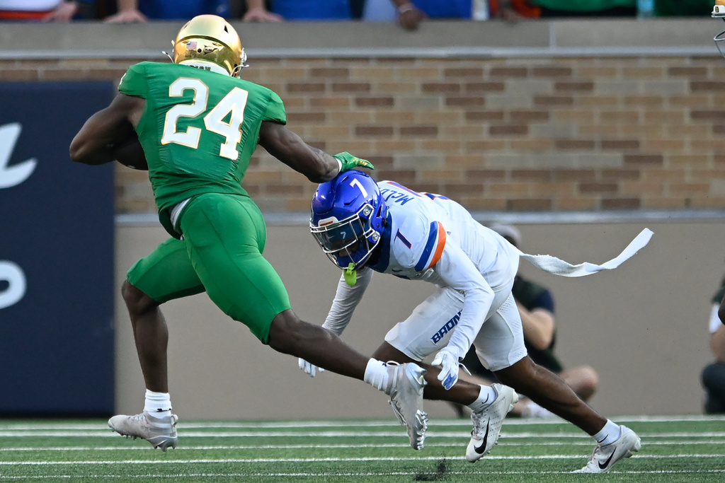 Notre Dame running back Jadarian Price (24) rushes for a 52 yard touchdown against Boise State's A'Marion McCoy (7) during the fourth quarter of an NCAA college football game Saturday, Oct. 4, 2025, in South Bend, Ind. (AP Photo/Paul Beaty)