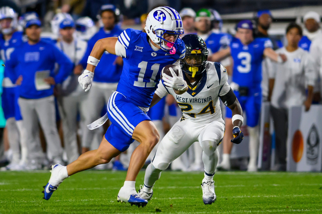 BYU wide receiver Parker Kingston (11) runs the football in for a touchdown after making a catch during the first half of an NCAA college football game against West Virginia, Friday, Oct. 3, 2025, in Provo, Utah. (AP Photo/Tyler Tate)