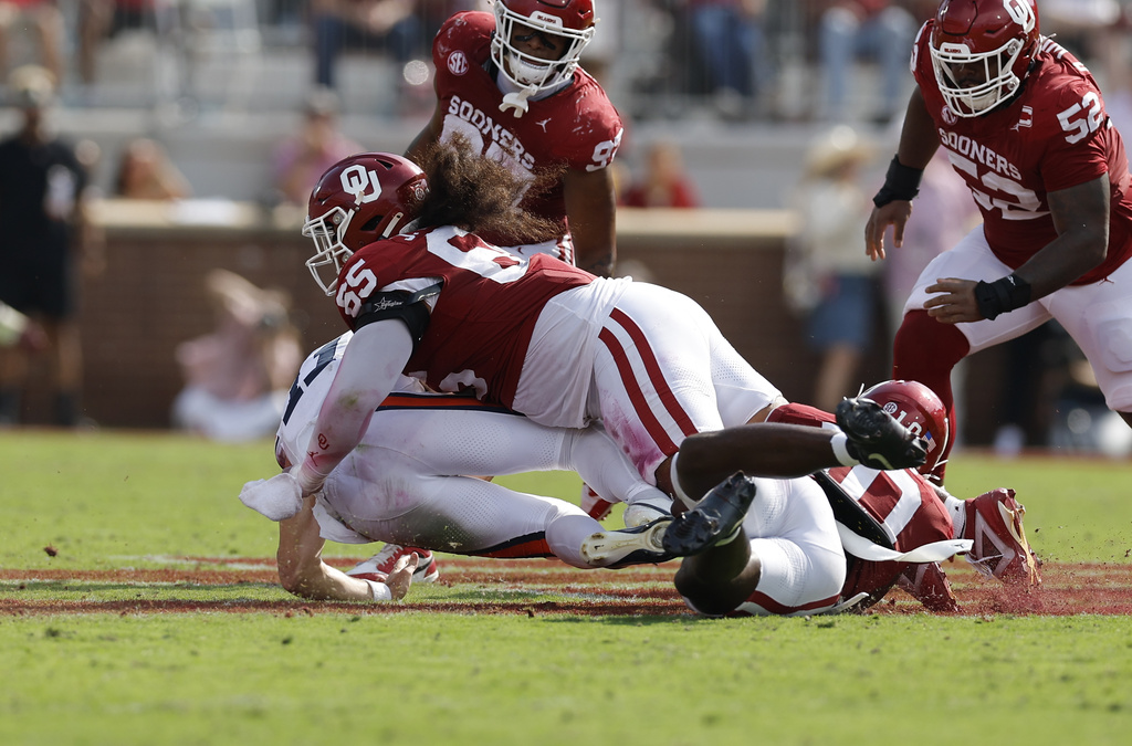 Oklahoma defensive lineman Jayden Jackson (65) tackles Auburn quarterback Jackson Arnold (11) during the first half of an NCAA college football game Saturday, Sept. 20, 2025, in Norman, Okla. (AP Photo/Alonzo Adams)