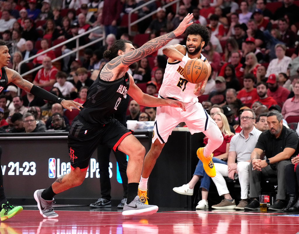 Denver Nuggets guard Jamal Murray (27) passes the ball against Houston Rockets center Steven Adams (12) during the first half of an NBA Cup basketball game, Friday, Nov. 21, 2025, in Houston. (AP Photo/Karen Warren)