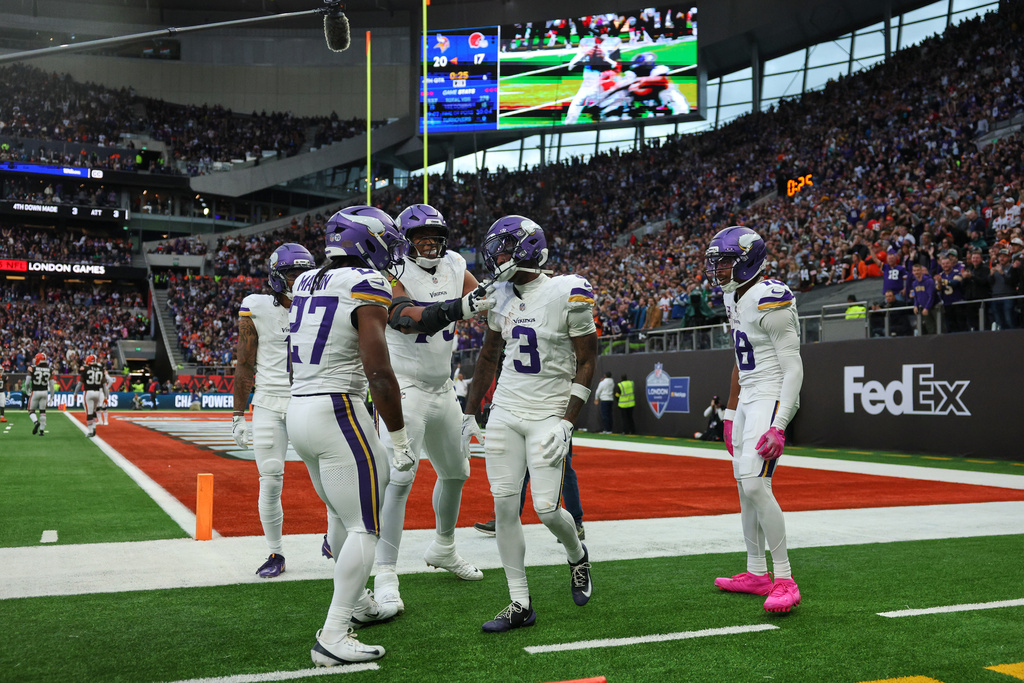 Minnesota Vikings wide receiver Jordan Addison (3) celebrates with his teammates after scoring a touchdown during the second half of the NFL game between Minnesota Vikings and Cleveland Browns at the Tottenham Hotspur stadium in London, Sunday, Oct. 5, 2025. (AP Photo/Ian Walton)