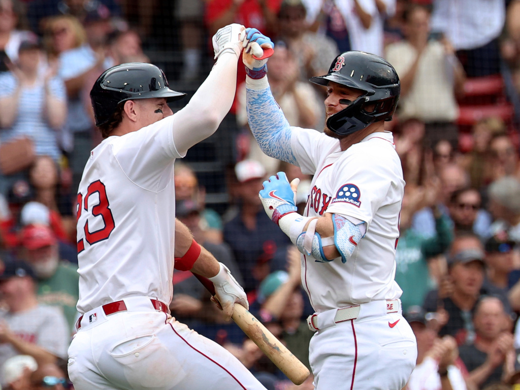 Boston Red Sox's Romy Gonzalez, left, and Trevor Story, right, celebrate after Story's home run during the sixth inning of a baseball game against the Cleveland Guardians, Monday, Sept. 1, 2025, in Boston. (AP Photo/Mark Stockwell)