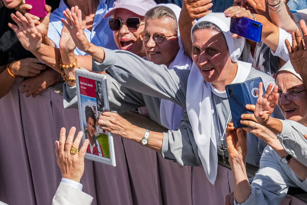 FILE - Pope Leo XIV is greeted by faithful as he leaves after celebrating the canonization Mass of Carlo Acutis and Pier Giorgio Frassati in St. Peter's Square at the Vatican Sept. 7, 2025. (AP Photo/Andrew Medichini, File)