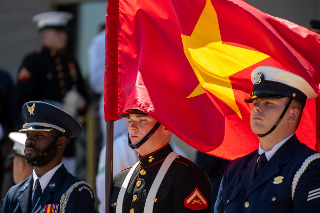 FILE - A U.S. Marine honor guard member holds the Vietnamese flag during an honor cordon at the Pentagon to welcome Vietnamese Defense Minister Gen. Phan Van Giang, Sept. 9, 2024, in Washington. (AP Photo/Kevin Wolf, File)