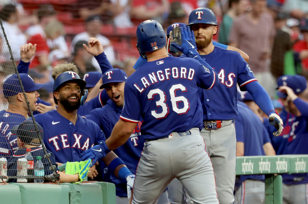 Texas Rangers designated hitter Wyatt Langford (36) celebrates after his home run during the first inning of a baseball game against the Boston Red Sox, Sunday, June 14, 2026, in Boston. (AP Photo/Mark Stockwell)