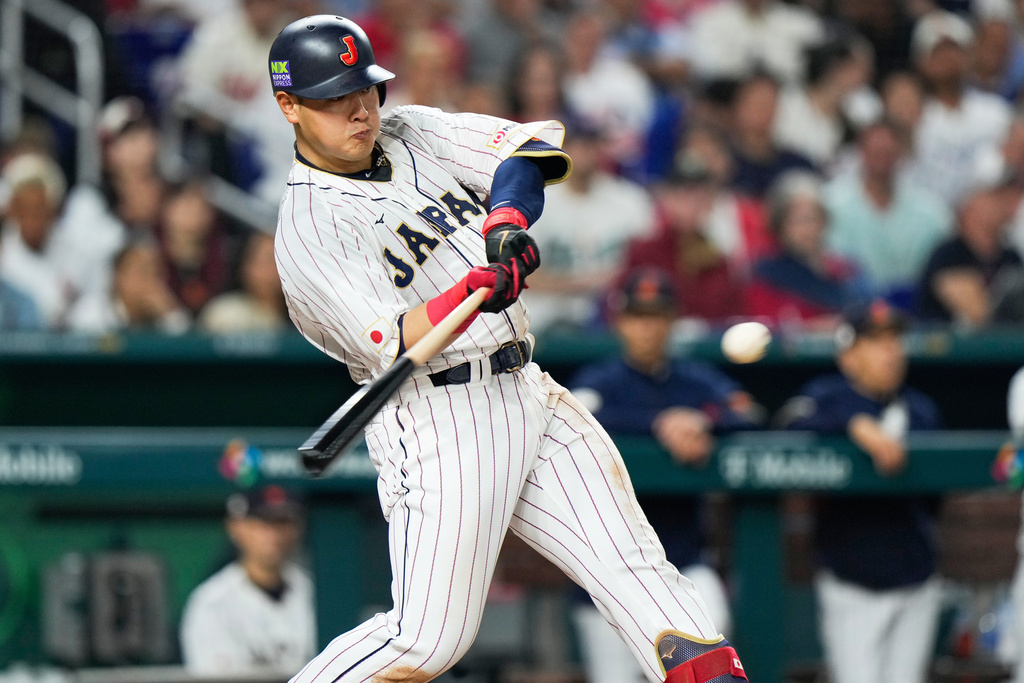 FILE - Japan's Kazuma Okamoto hits a home run during fourth inning of a World Baseball Classic championship game against the United States, March 21, 2023, in Miami. (AP Photo/Wilfredo Lee, File)