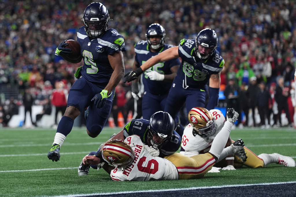 Seattle Seahawks running back Kenneth Walker III (9) scores a touchdown during the second half of an NFL football divisional playoff game against the San Francisco 49ers, Saturday, Jan. 17, 2026, in Seattle. (AP Photo/Lindsey Wasson)