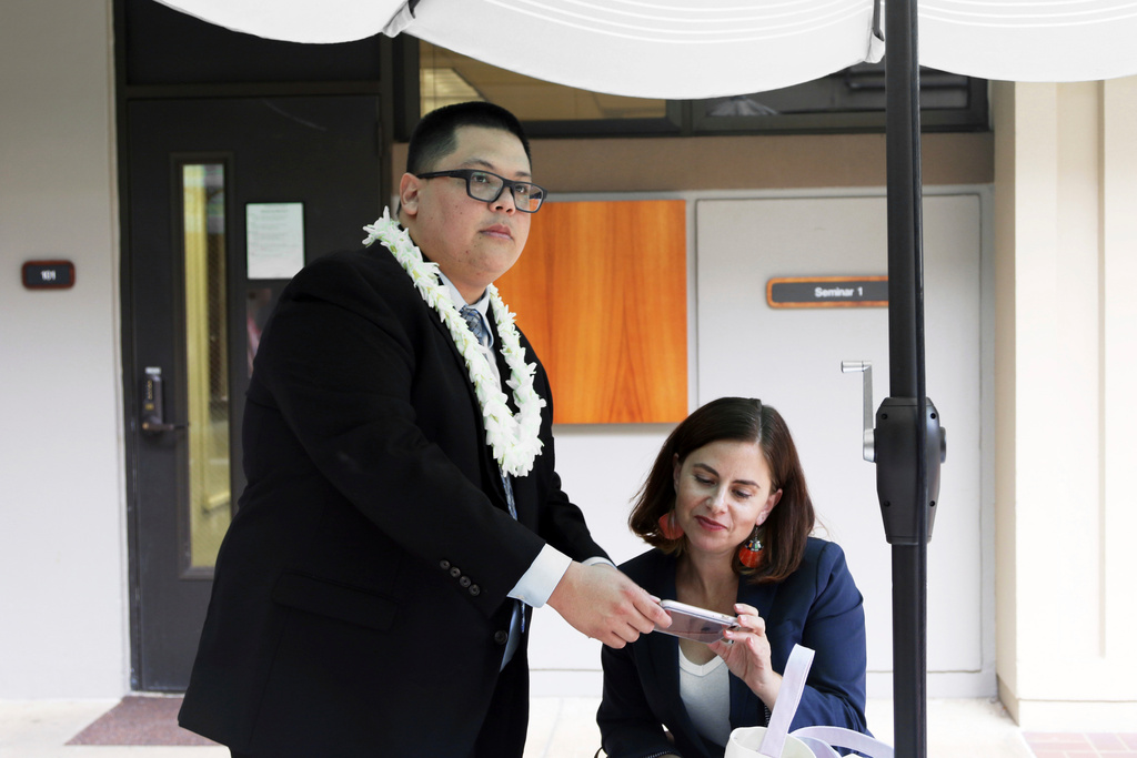 FILE -Attorney Julian Aguon, left, meets with colleague Addie Rolnick after arguing before a panel of U.S. Circuit Court of Appeals judges in Honolulu on Oct. 10, 2018. (AP Photo/Jennifer Sinco Kelleher, File)