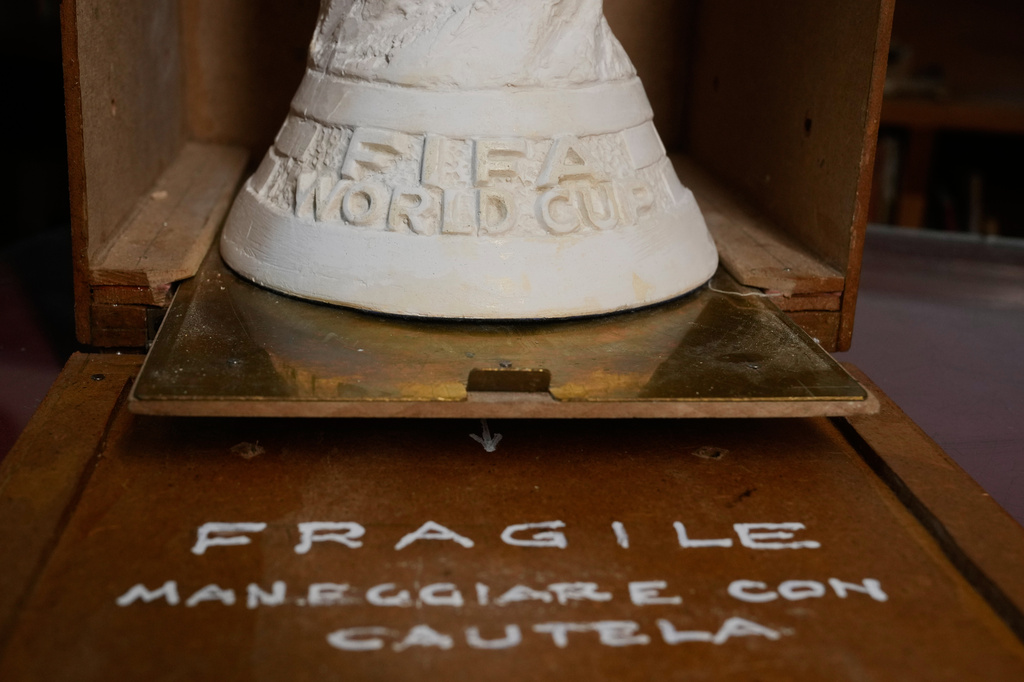 The original plaster World Cup trophy sculpture is displayed into a wooden case in a warehouse in Pioltello, Italy, Saturday, July 11, 2026. (AP Photo/Luca Bruno)