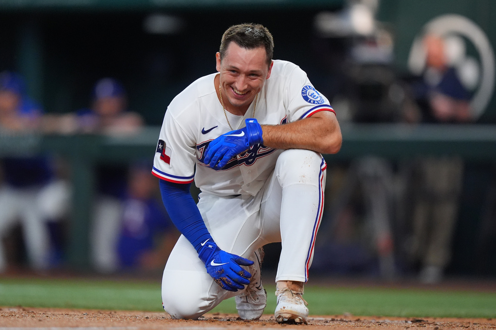 Texas Rangers' Wyatt Langford smiles after falling down during an at bat during the second inning of a baseball game against the Seattle Mariners, Saturday, July 25, 2026, in Arlington, Texas. (AP Photo/LM Otero)
