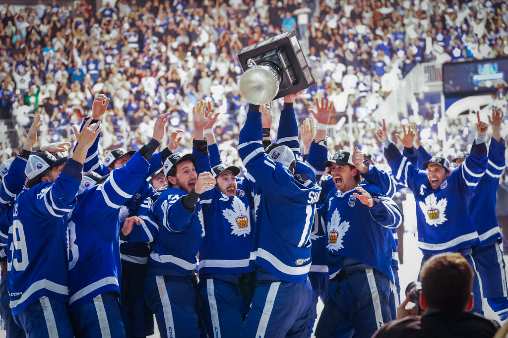 Toronto Marlies forward Logan Shaw (11) lifts the Calder Cup to celebrate with his teammates after winning Game 5 of the AHL Calder Cup Final over the Chicago Wolves in Toronto on Friday, June 19, 2026. (Arlyn McAdorey/The Canadian Press via AP)