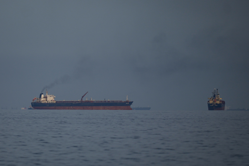 Oil tankers and cargo ships line up in the Strait of Hormuz as seen from Khor Fakkan, United Arab Emirates, Wednesday, March 11, 2026. (AP Photo/Altaf Qadri)