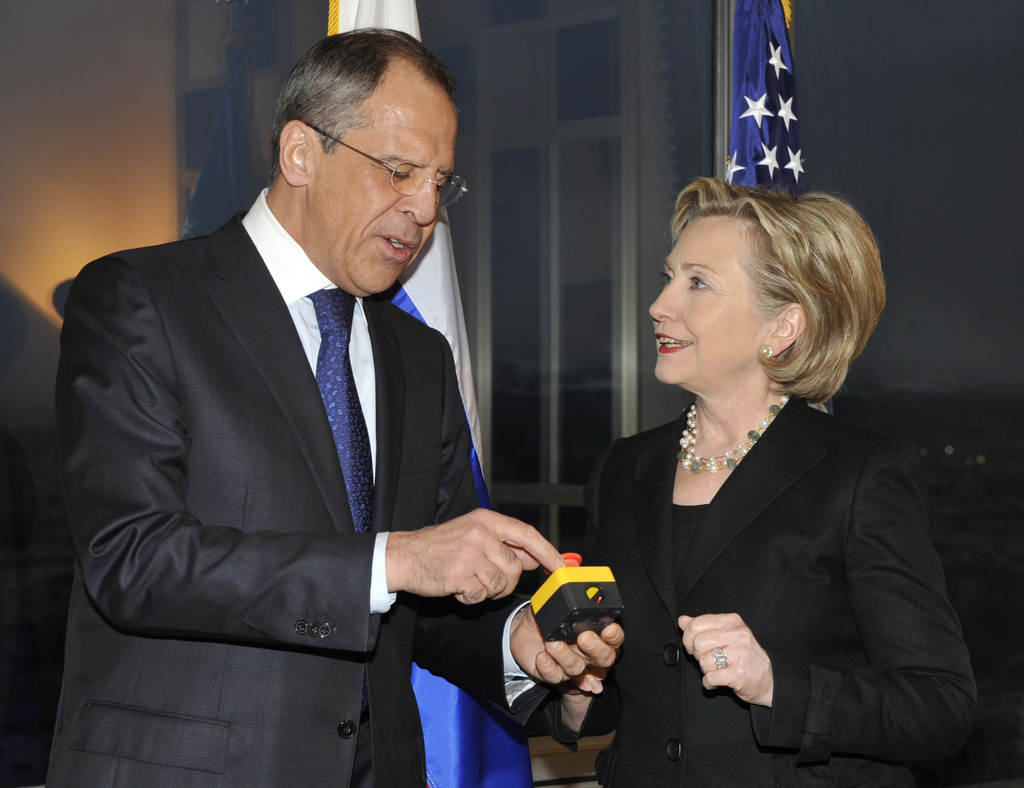 FILE - U.S. Secretary of State Hillary Clinton, right, presents Russian Foreign Minister Sergey Lavrov with a device with a red button symbolizing the intention to "reset" U.S.-Russian relations during their meeting in Geneva, Switzerland on March 6, 2009. (AP Photo, File)