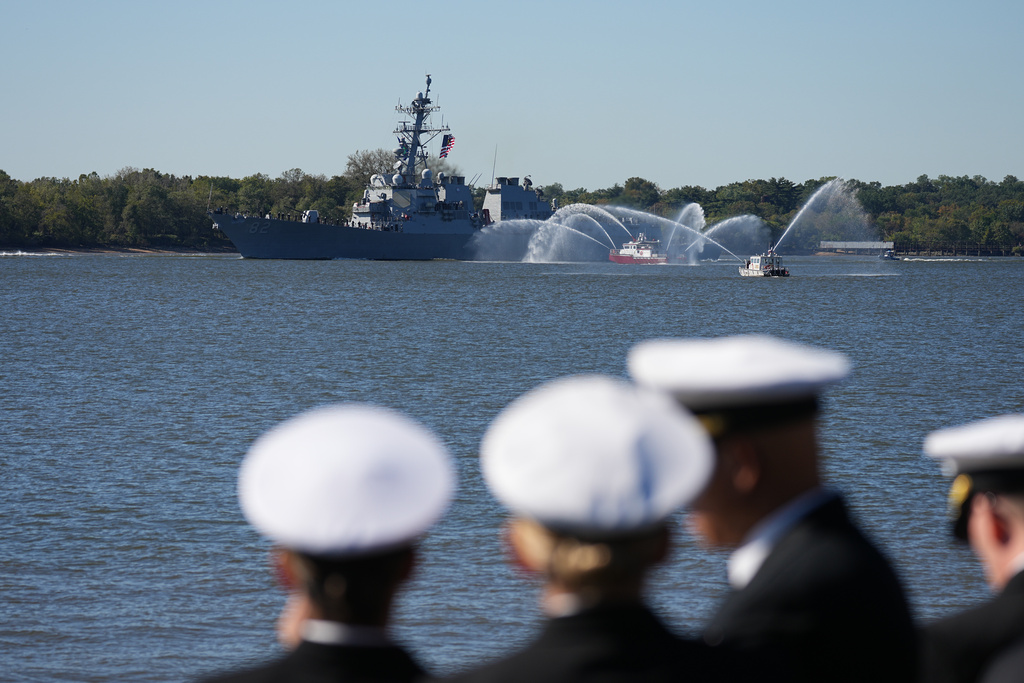 Spectators look on as U.S. Navy ships pass the viewing stand during the 250th anniversary of the founding of the U.S. Navy and Marine Corps, along the Delaware River, Thursday, Oct. 9, 2025, in Philadelphia. (AP Photo/Matt Rourke)