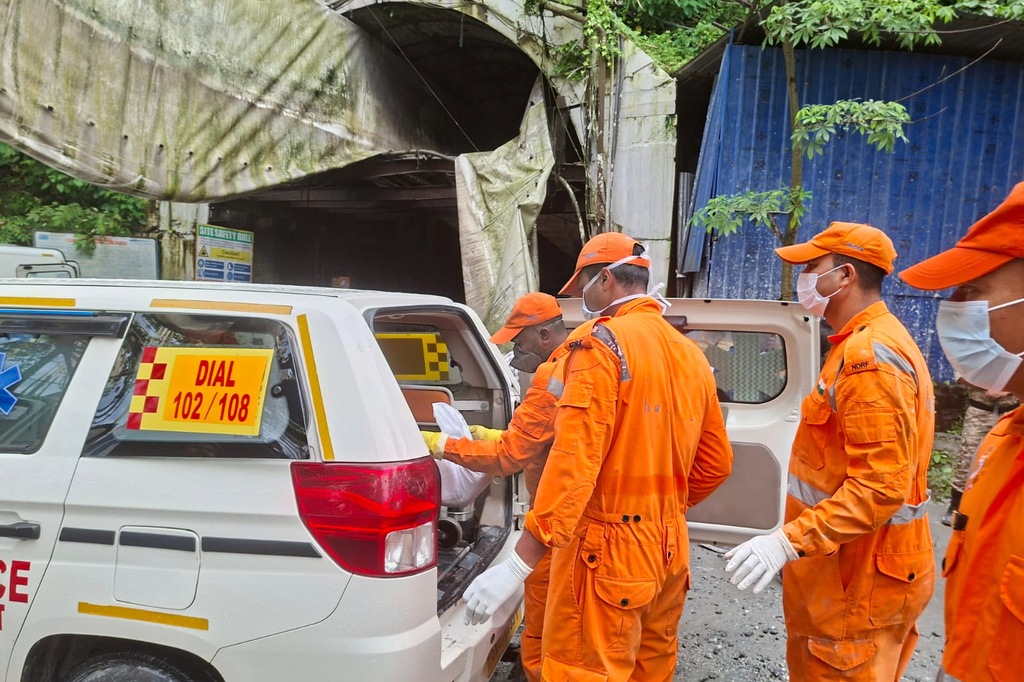 Rescue workers carry the body of a victim into an ambulance outside the entrance to an under-construction tunnel at a hydropower project in Samardung village, about 40 kilometers (25 miles) from Gangtok, India, Tuesday, July 21, 2026. (AP Photo)