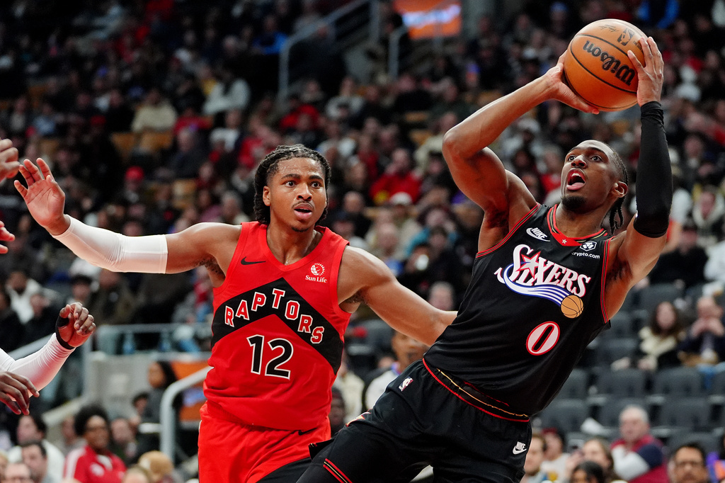 Philadelphia 76ers guard Tyrese Maxey (0) looks to shoot as Toronto Raptors forward Collin Murray-Boyles (12) watches during second-half NBA basketball game action in Toronto, Sunday, Jan. 11, 2026. (Frank Gunn/The Canadian Press via AP)