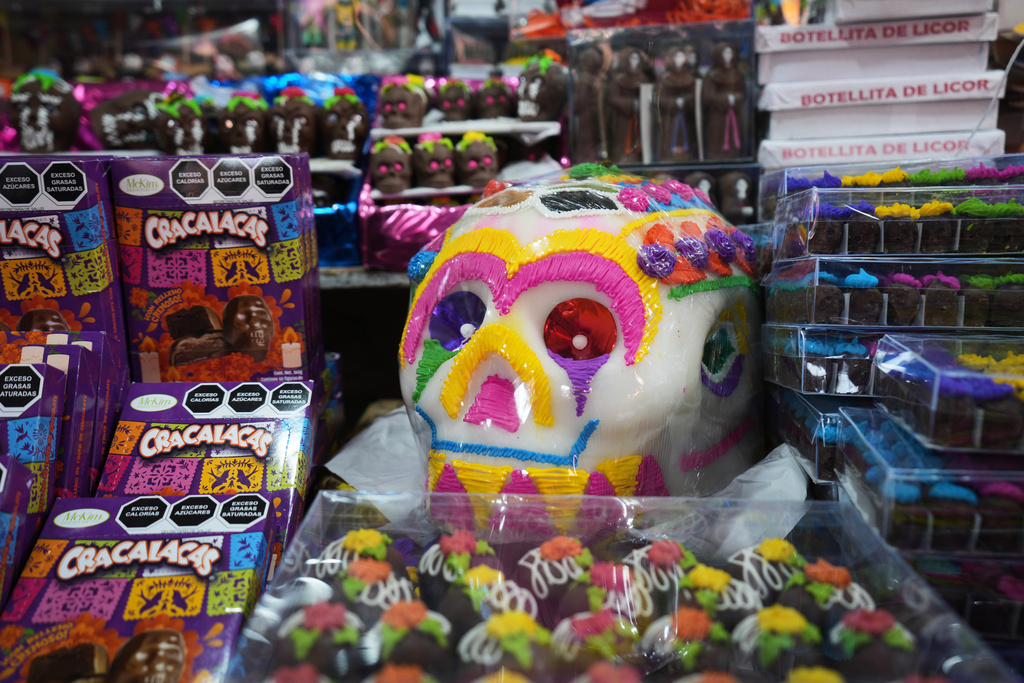 An over-sized sugar skull, referred to as a “calaverita” or little skull, traditionally added to Day of the Dead altars honoring deceased loved ones, is displayed for sale at the Dulces de Ampudia market in Mexico City, Thursday, Oct. 30, 2025. (AP Photo/Claudia Rosel)