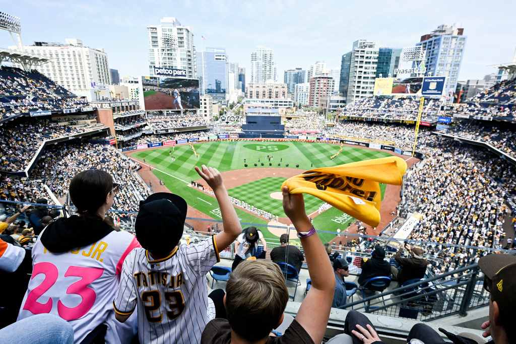 FILE - Fans cheer before an opening day baseball game between the San Francisco Giants and the San Diego Padres, Thursday, March 28, 2024, in San Diego. (AP Photo/Denis Poroy, File)