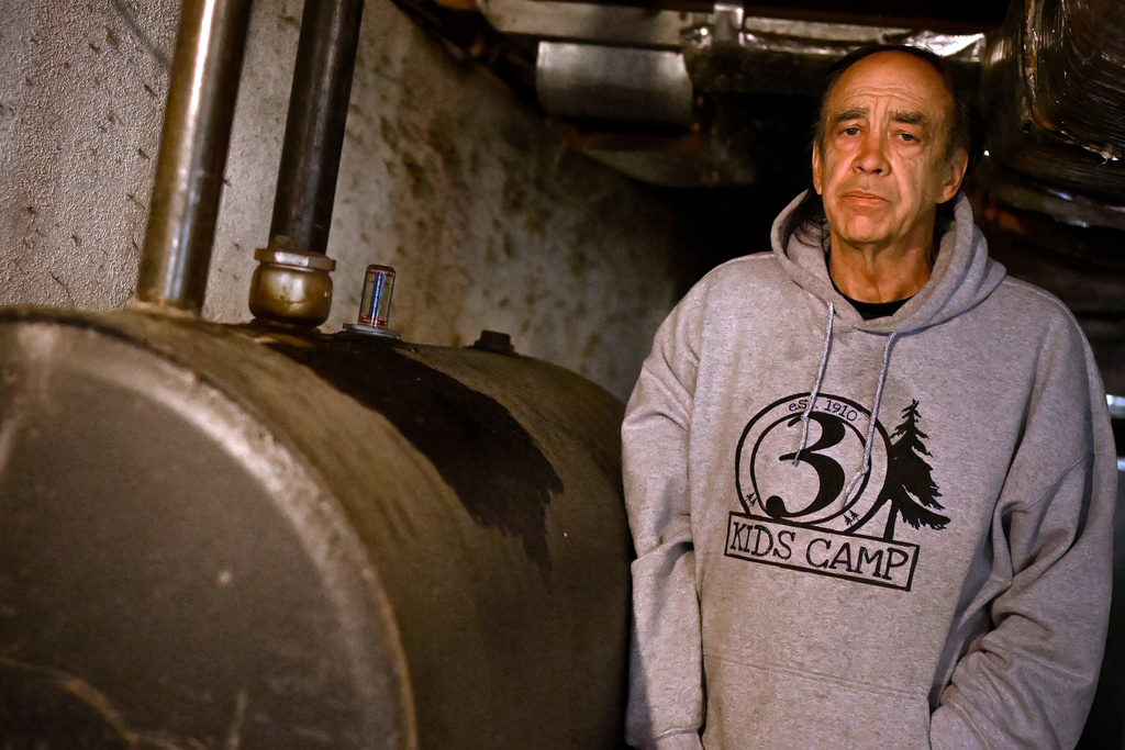 Mark Bain, who is part of the Low Income Home Energy Assistance Program, stands next to his oil tank and says he hopes that he will have enough oil to outlast the shutdown, in Bloomfield, Conn., Monday, Oct. 27, 2025. (AP Photo/Jessica Hill)