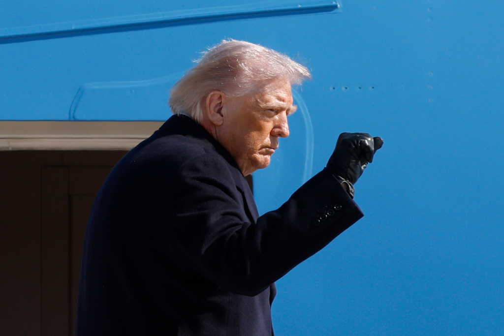 President Donald Trump gestures from the stairs of Air Force One upon his arrival at Joint Base Andrews, Md., Friday, Feb. 27, 2025. (AP Photo/Luis M. Alvarez)
