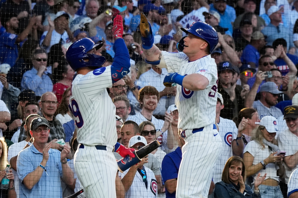 Chicago Cubs' Pete Crow-Armstrong, right, celebrates with Michael Busch after hitting a solo home run during the first inning of a baseball game against the Colorado Rockies in Chicago, Monday, June 15, 2026. (AP Photo/Nam Y. Huh)