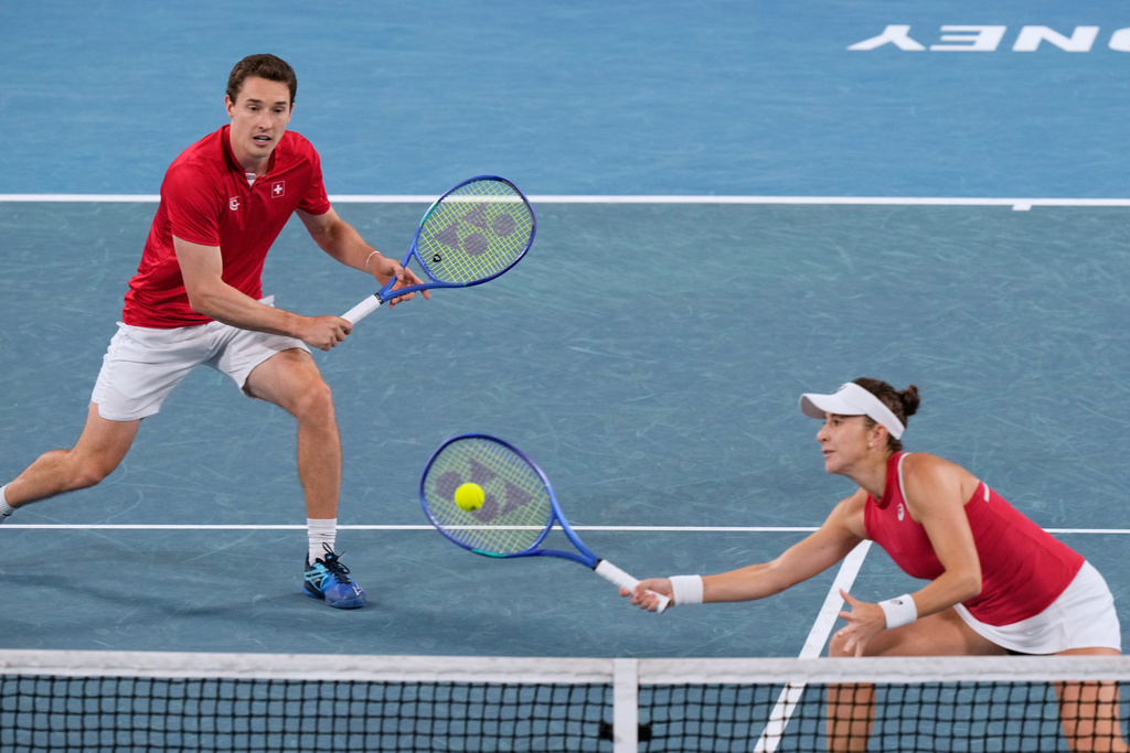 Belinda Bencic, right, and Jakub Paul of Switzerland compete against Katarzyna Kawa and Jan Zielinski of Poland in the doubles final match at the United Cup tennis tournament in Sydney, Sunday, Jan. 11, 2026. (AP Photo/Rick Rycroft)
