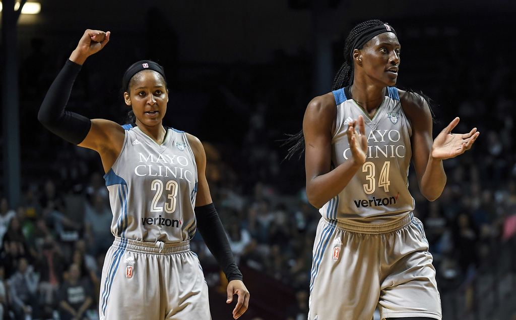 FILE - Minnesota Lynx forward Maya Moore (23) and Minnesota Lynx center Sylvia Fowles (34) celebrate after forcing a Washington Mystics timeout during the second half of a WNBA basketball game, Tuesday, Sept. 12, 2017 in Minneapolis. (Aaron Lavinsky/Star Tribune via AP, File)