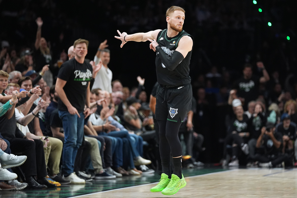 Minnesota Timberwolves guard Donte DiVincenzo (0) celebrates after making a 3-point shot during the first half in Game 3 of a first-round NBA basketball playoff series against the Denver Nuggets, Thursday, April 23, 2026, in Minneapolis. (AP Photo/Abbie Parr)