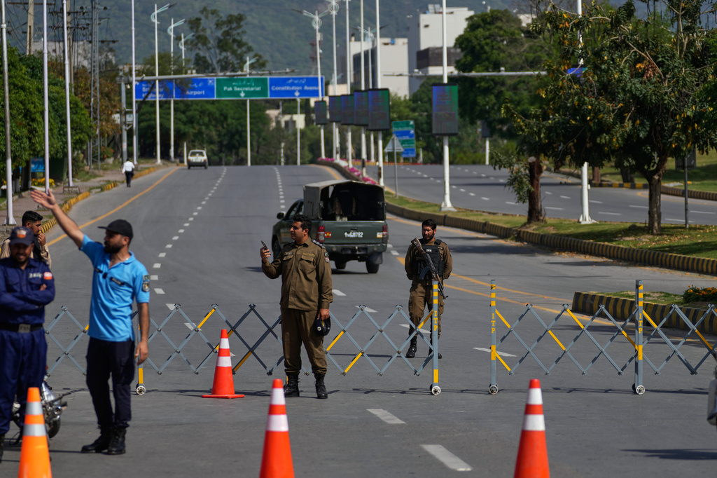 Police officers stand guard at a checkpoint ahead of the second round of negotiations between the U.S. and Iran, in Islamabad, Pakistan, Tuesday, April 21, 2026. (AP Photo/Anjum Naveed)